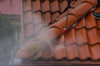 Washing The Old Roof With Pressurized Water